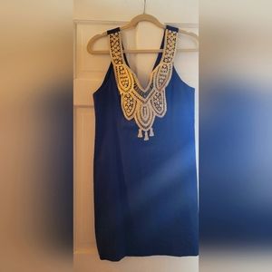 Lilly Pulitzer blue with gold embellishment on dress.